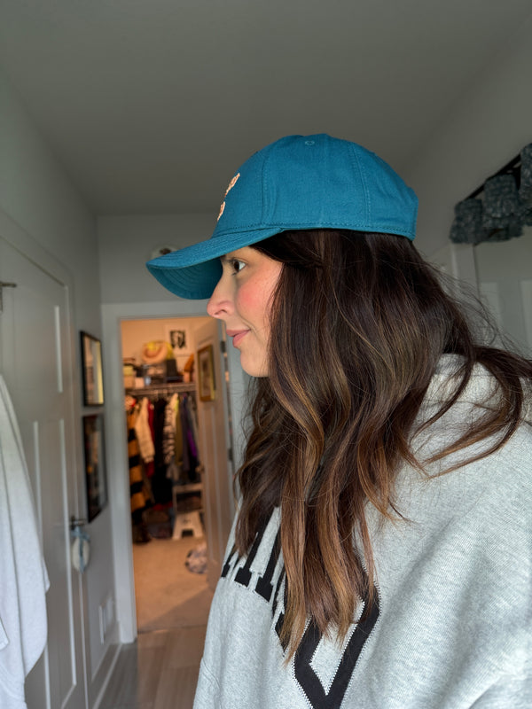 Teal cap with peach logo